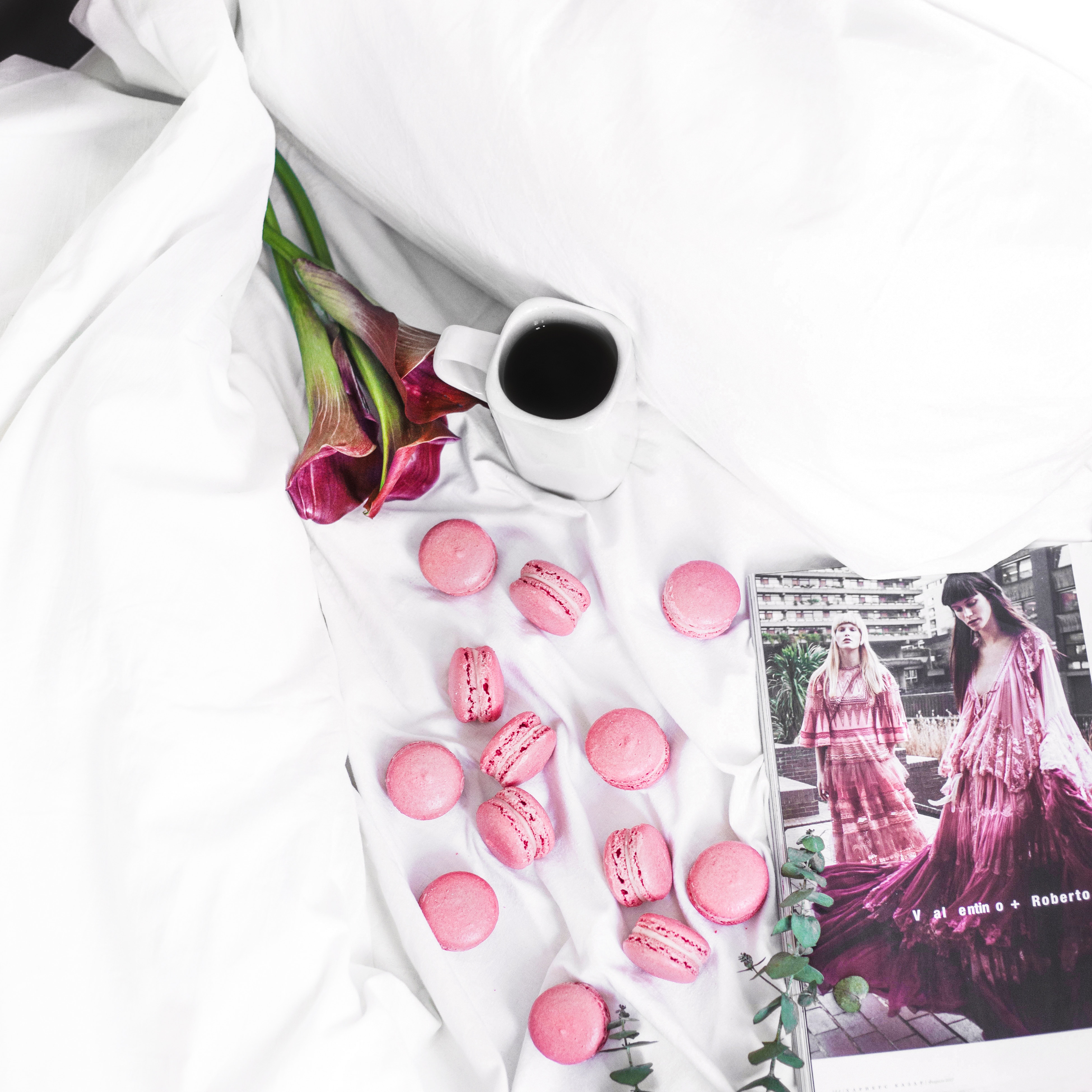 macarons and coffee on a bed free stock photo