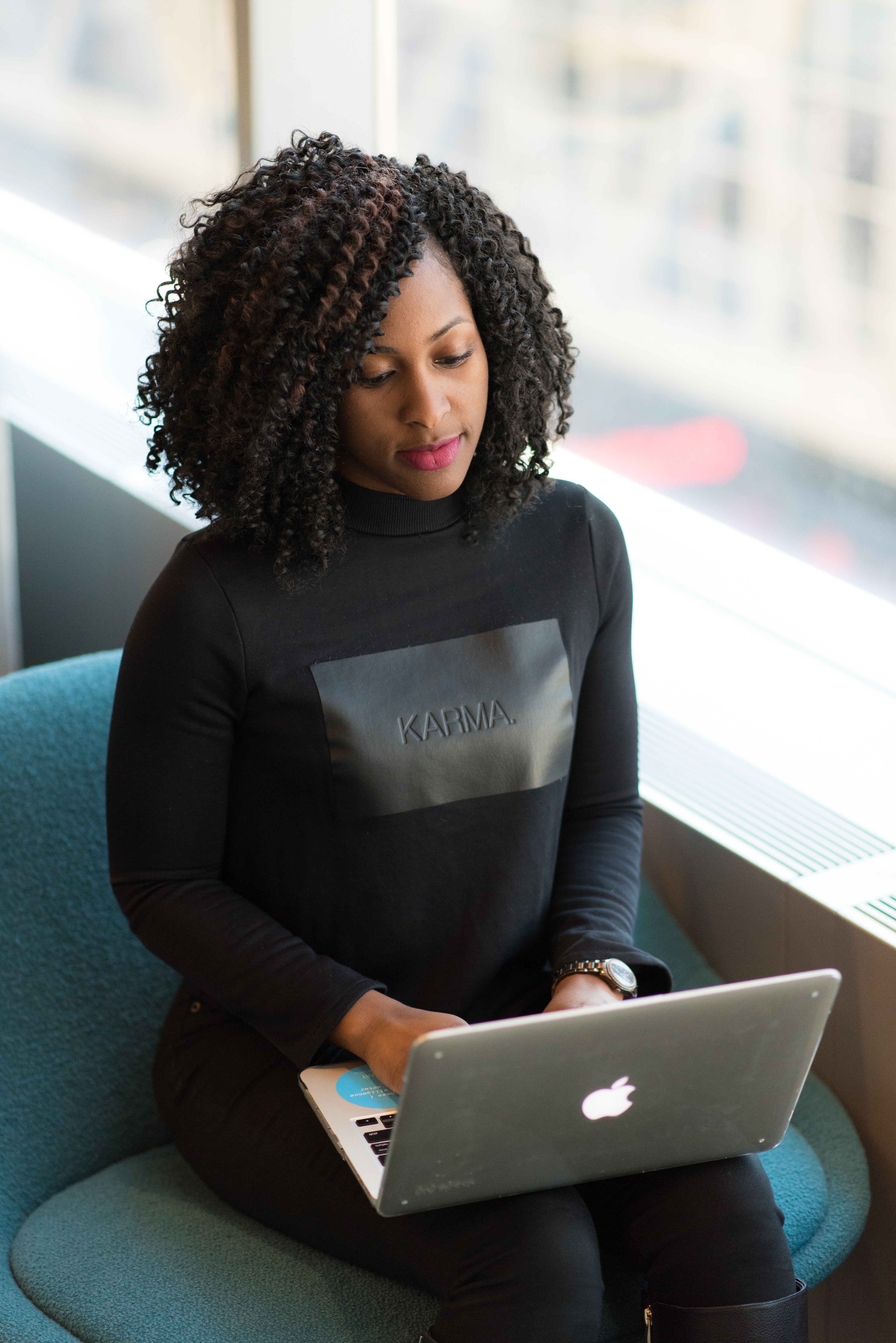 A woman in a black long-sleeved shirt using MacBook