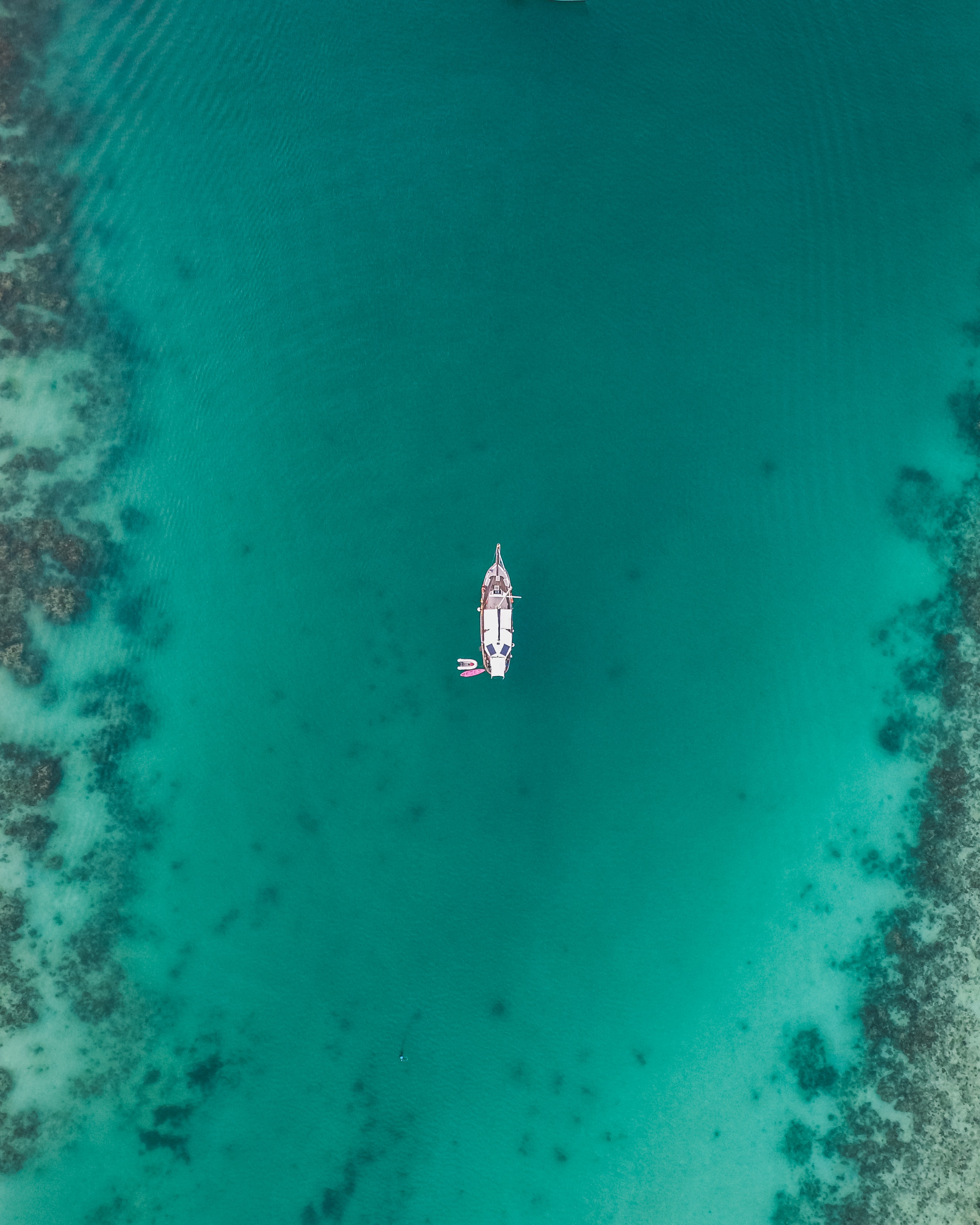 Aerial view of a white boat floating on the water
