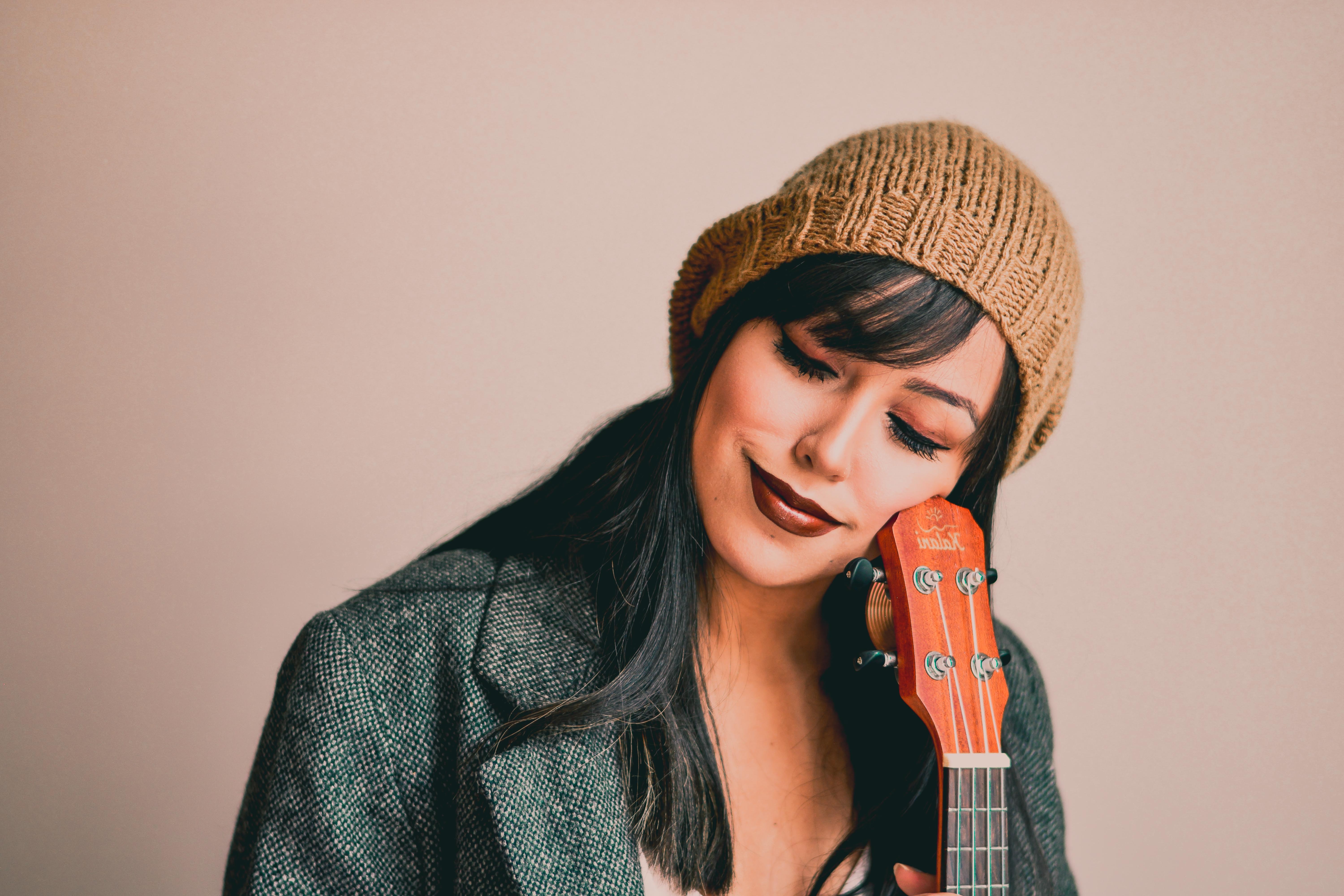 Photography of a woman holding ukulele