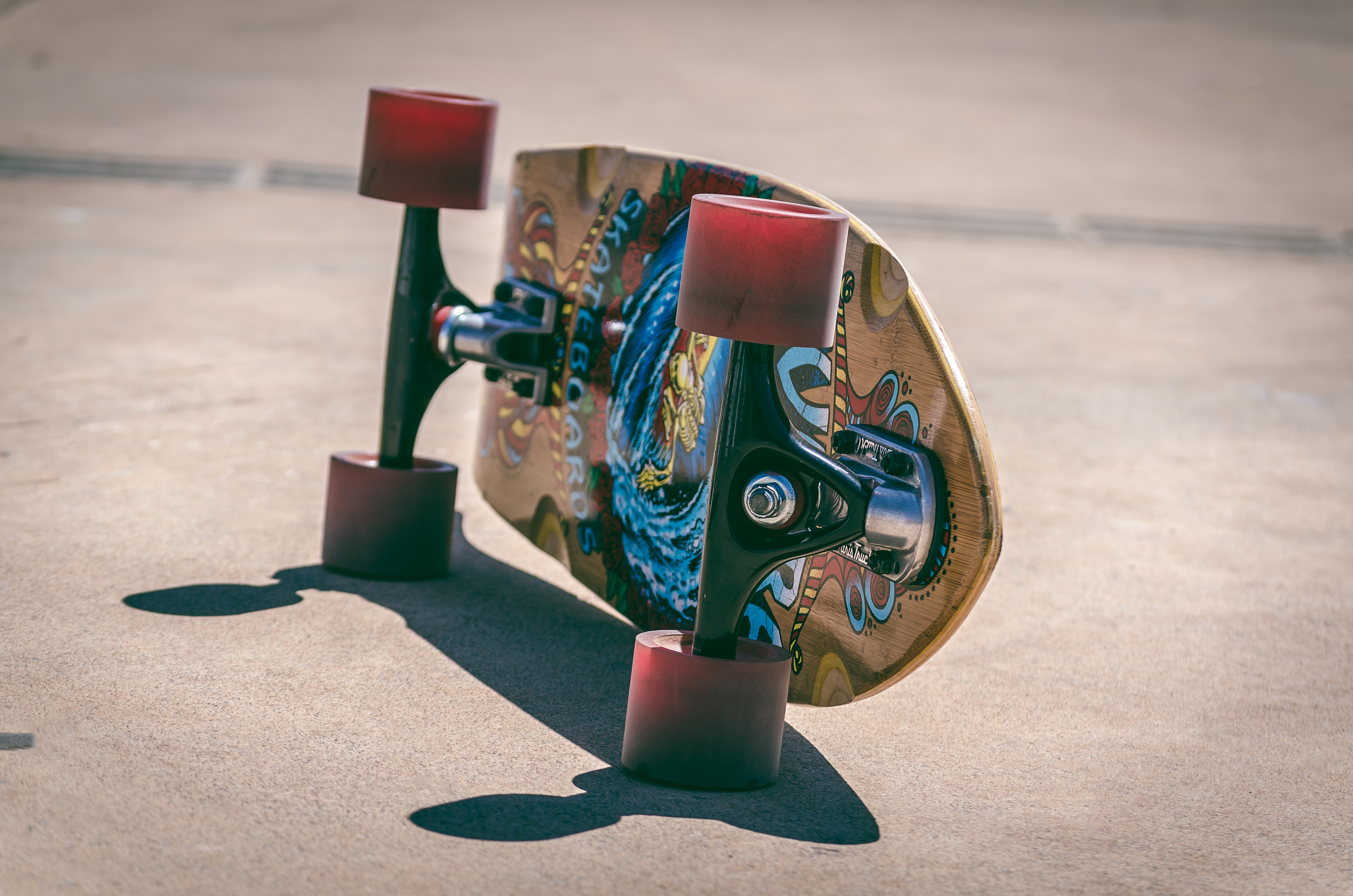 Shallow focus photography of a brown and blue skateboard