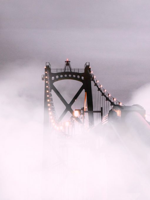 Suspension bridge covered with fog