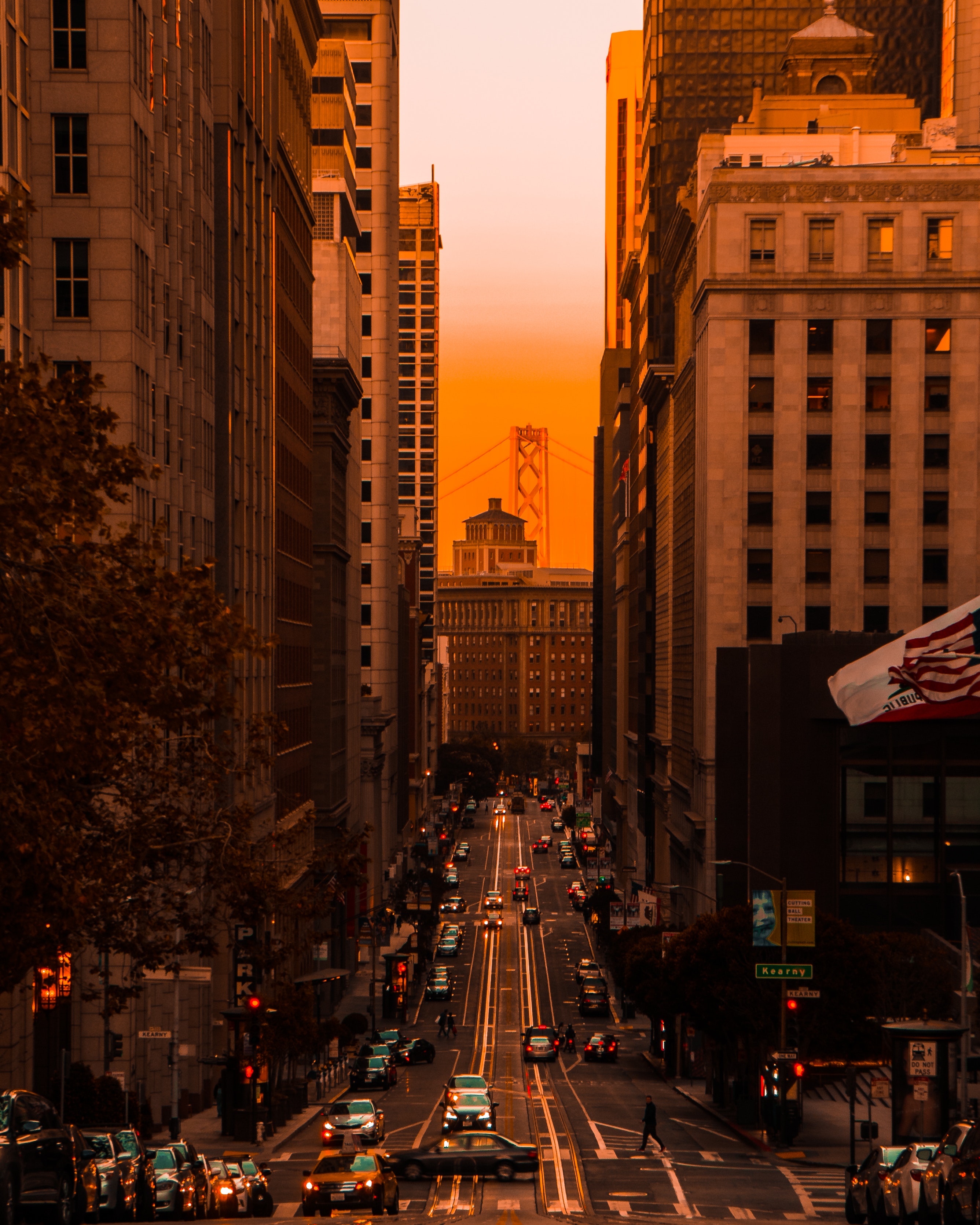 A road between two high-rise buildings during sunset