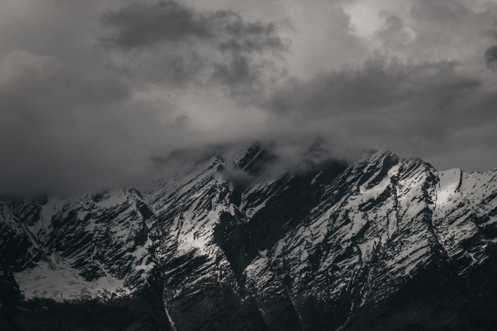 A snow-capped mountain during cloudy weather