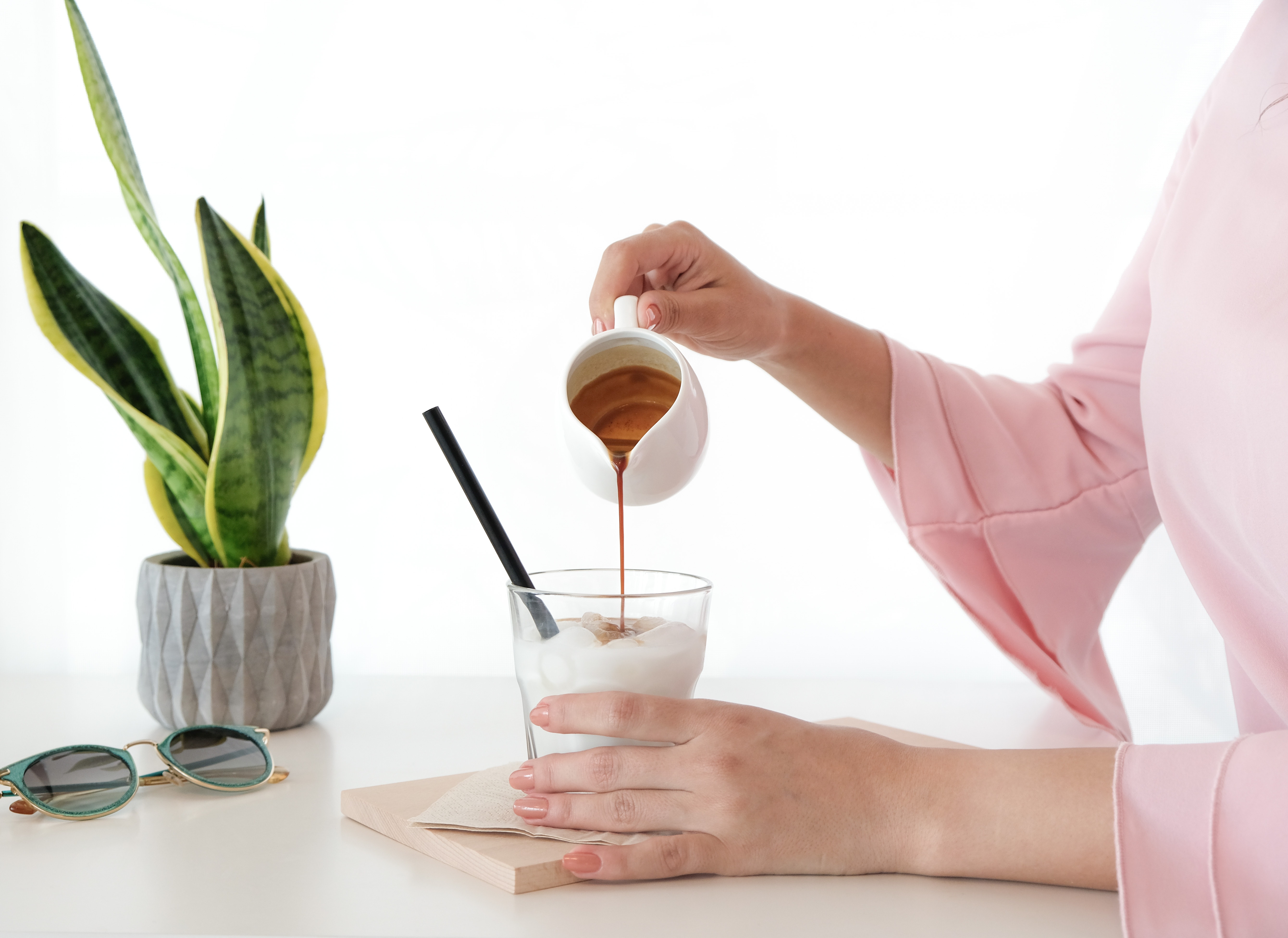 A woman pouring honey on a dessert