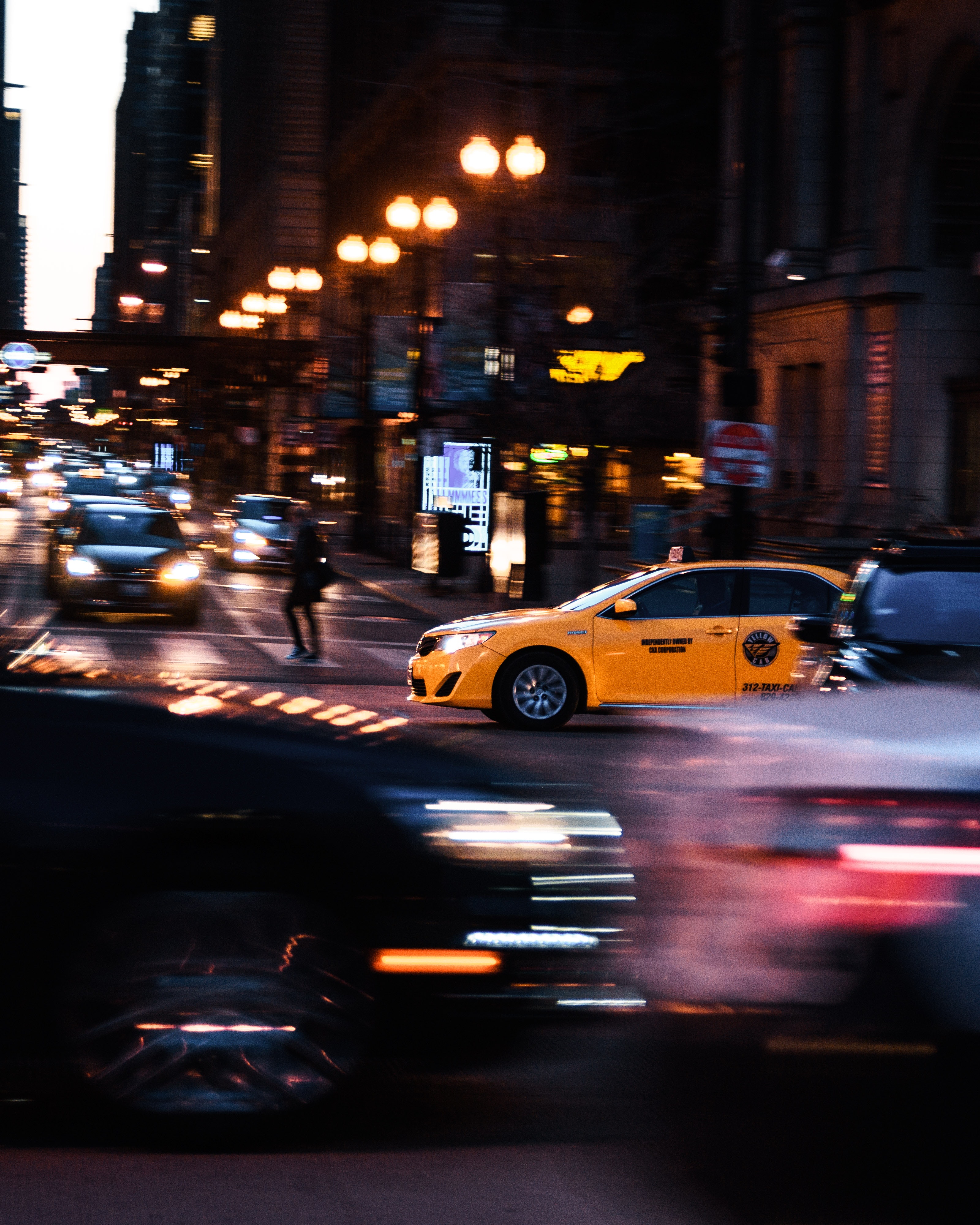 A yellow cab passing on the road