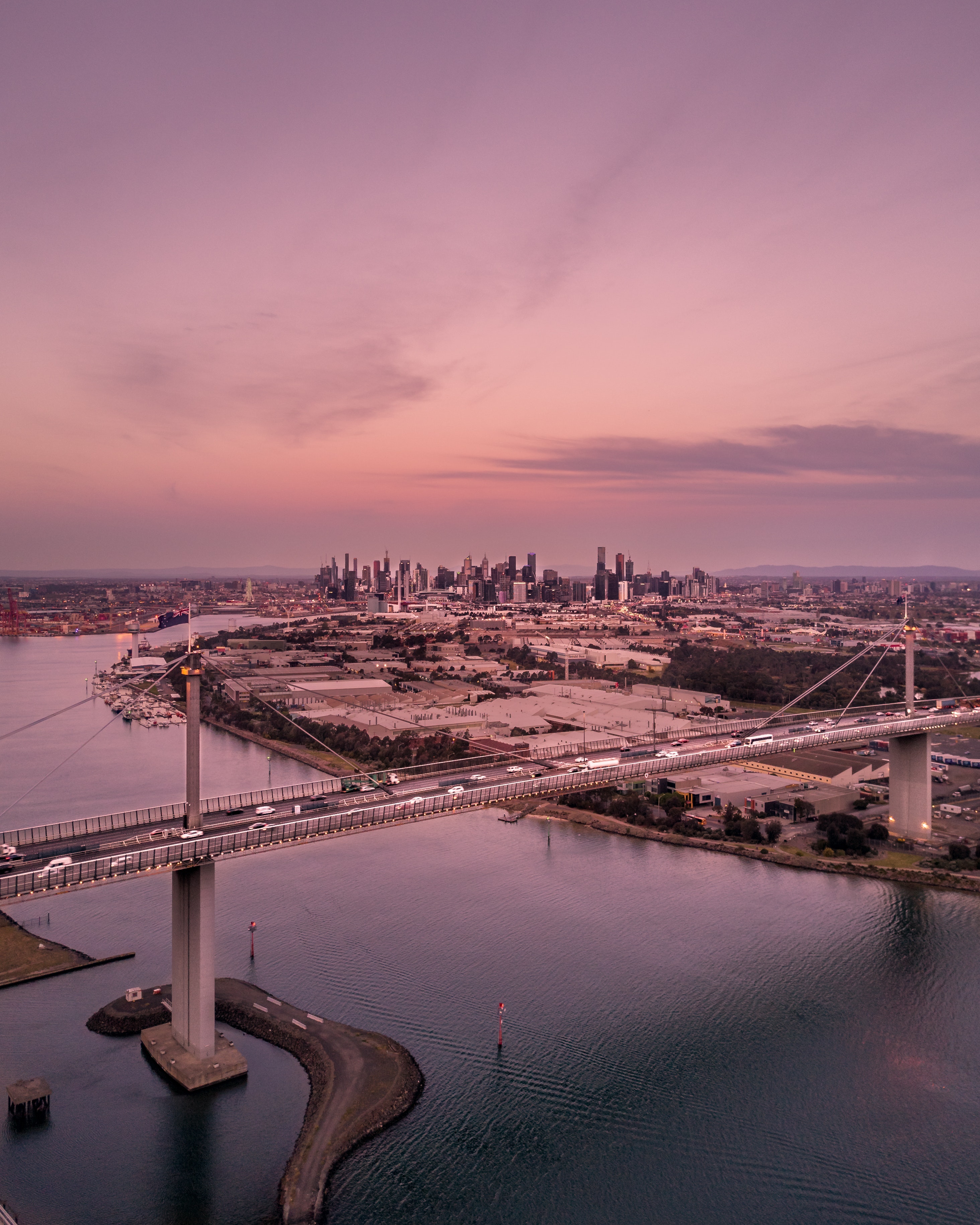 aerial-photography-of-city-buildings-and-bridge-during-sunset-pixeor