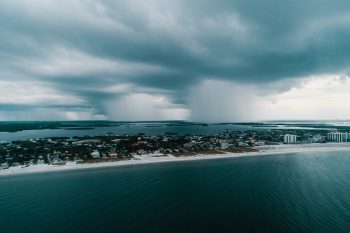 Aerial photography of city island under white clouds