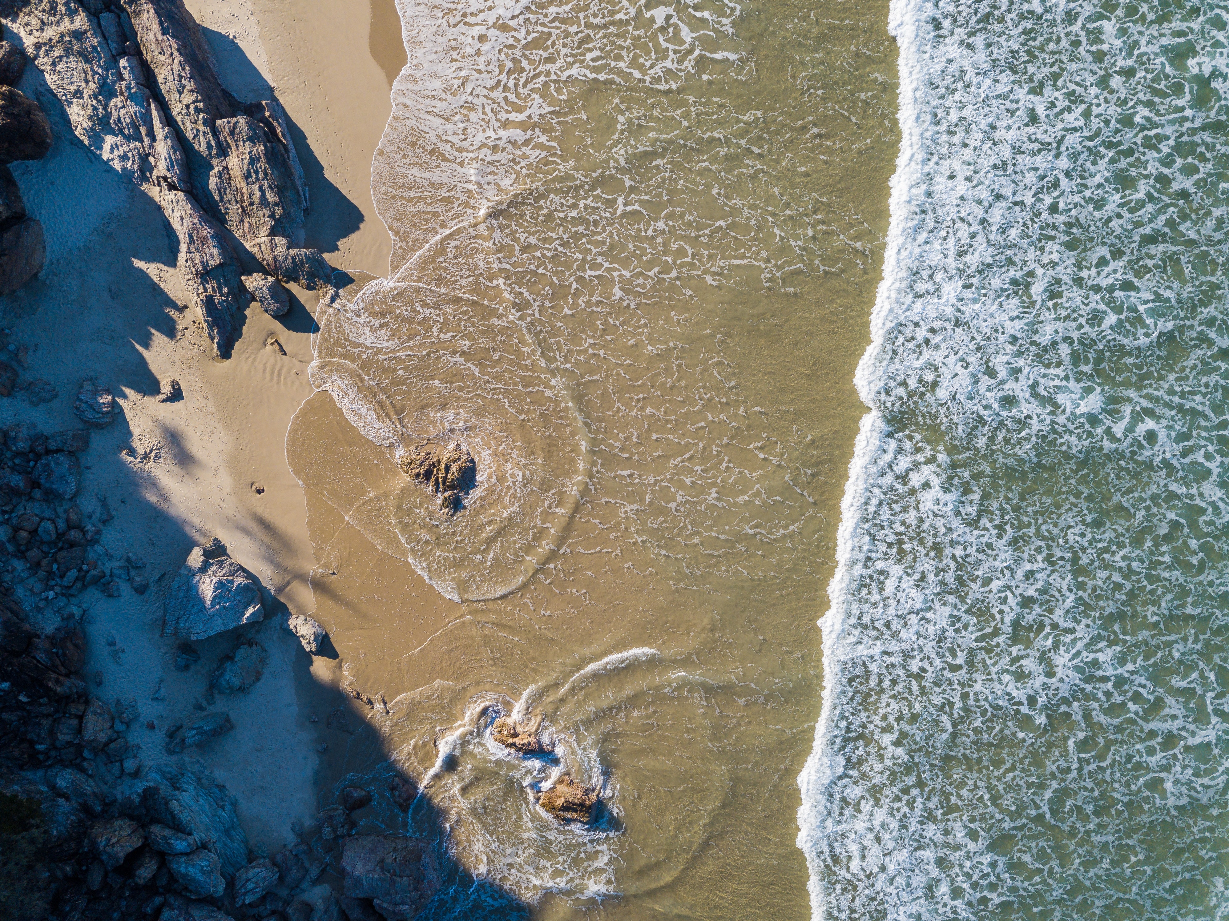 Aerial photography of sea by shore