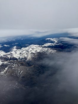 Bird eye's view of white mountains under clouds
