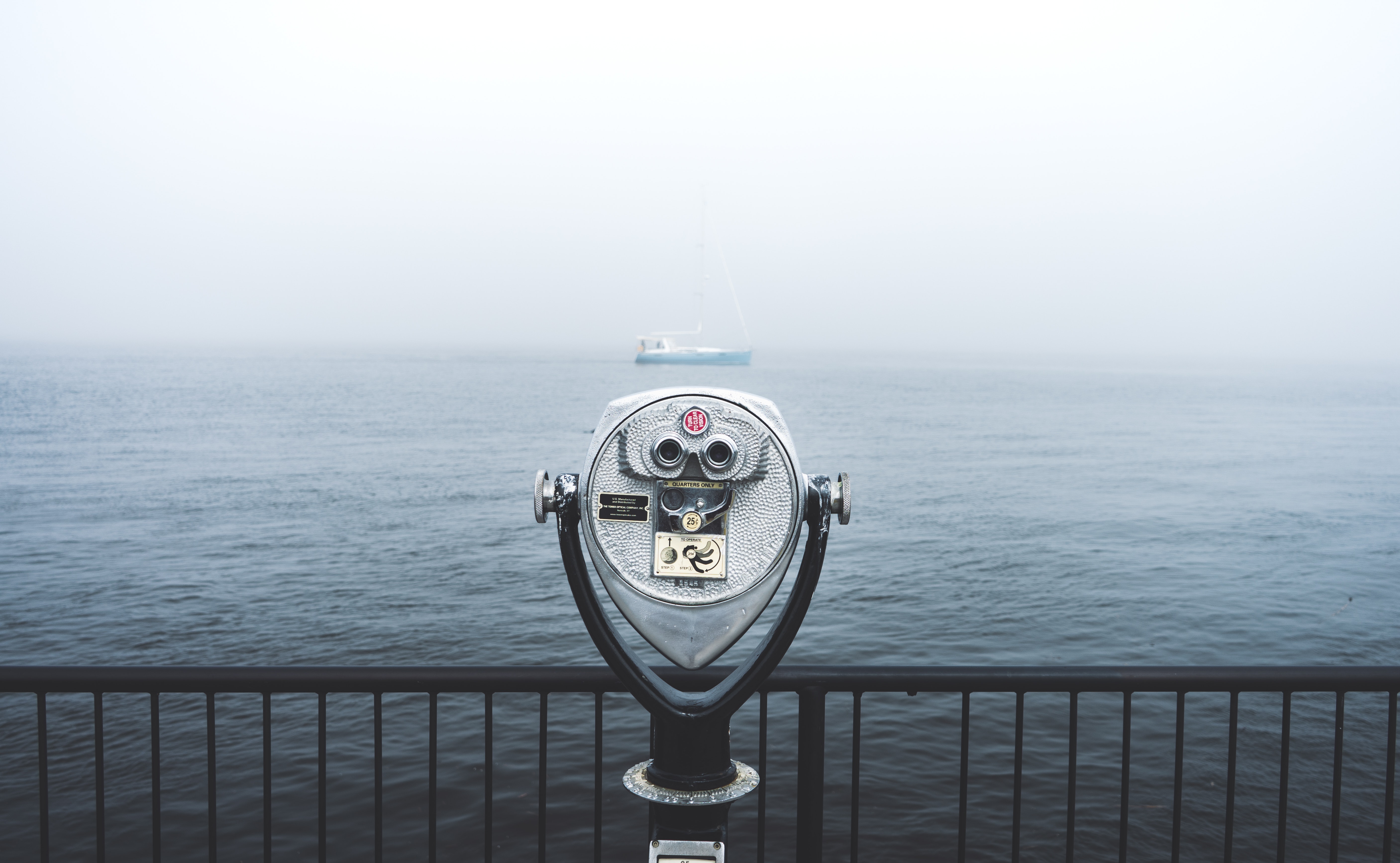 Coin operated binoculars looking over the ocean during foggy weather