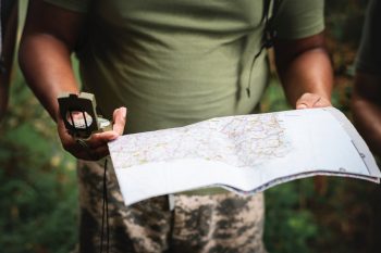 Photo of a person holding a map and compass