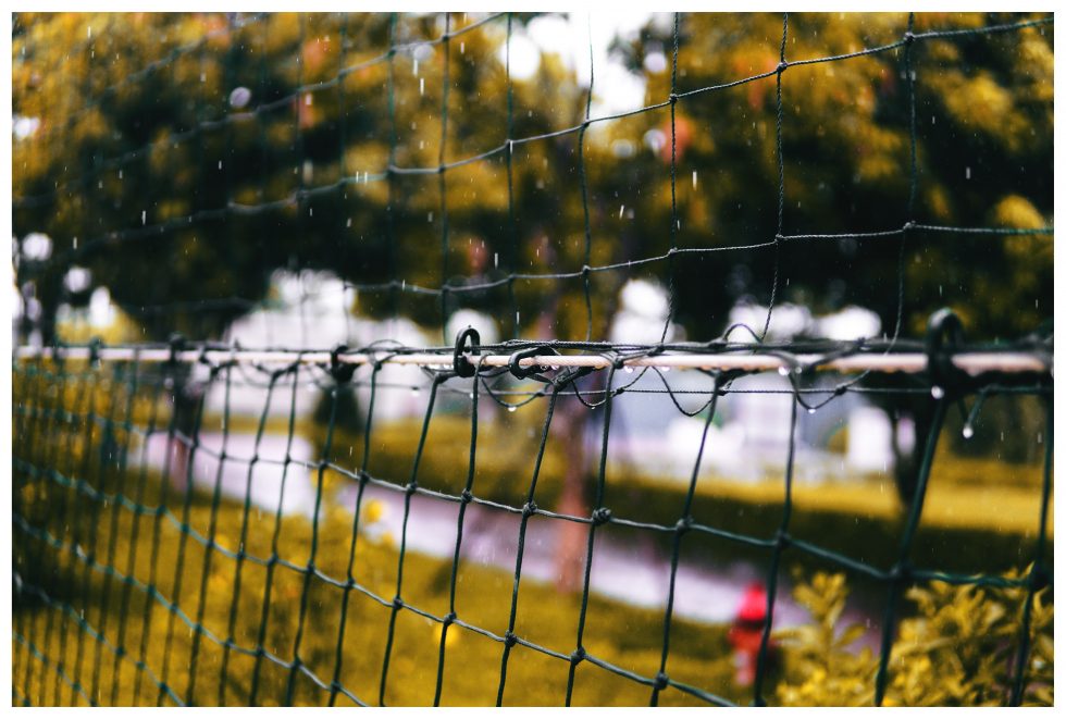 Shallow focus photography of a black net during raining
