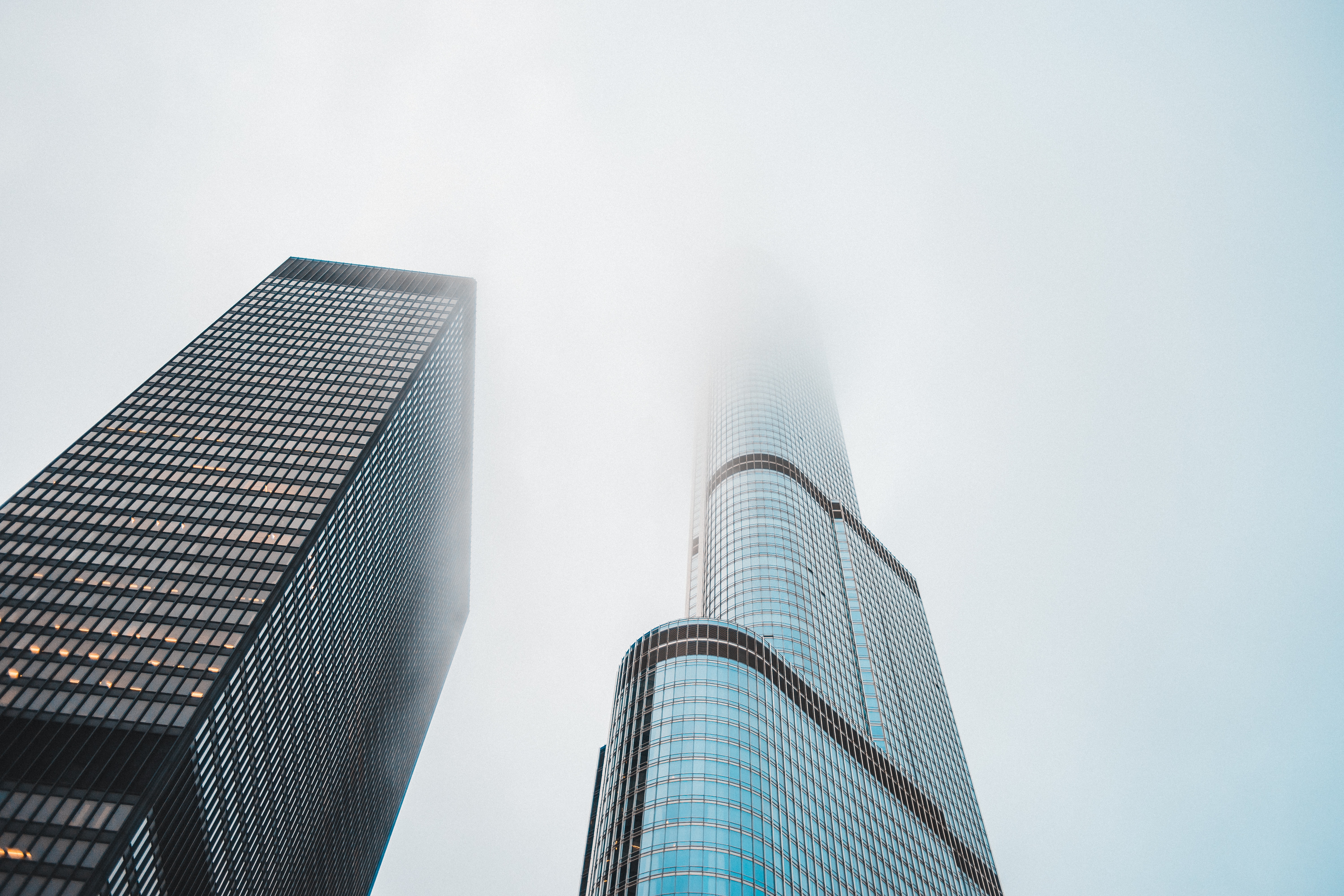 Worm's eye view of two skyscrapers under the fog
