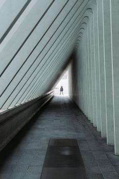 A person standing at the end of a hallway