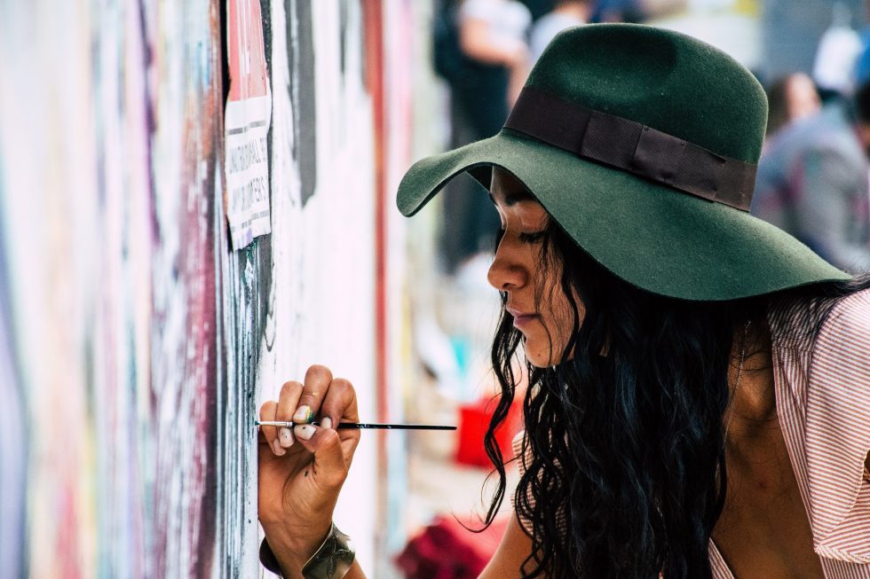A woman painting on a wall
