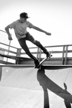 Grayscale photography of a man skateboarding on a ramp
