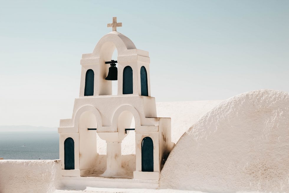 Photo of a church with a bell tower in Santorini