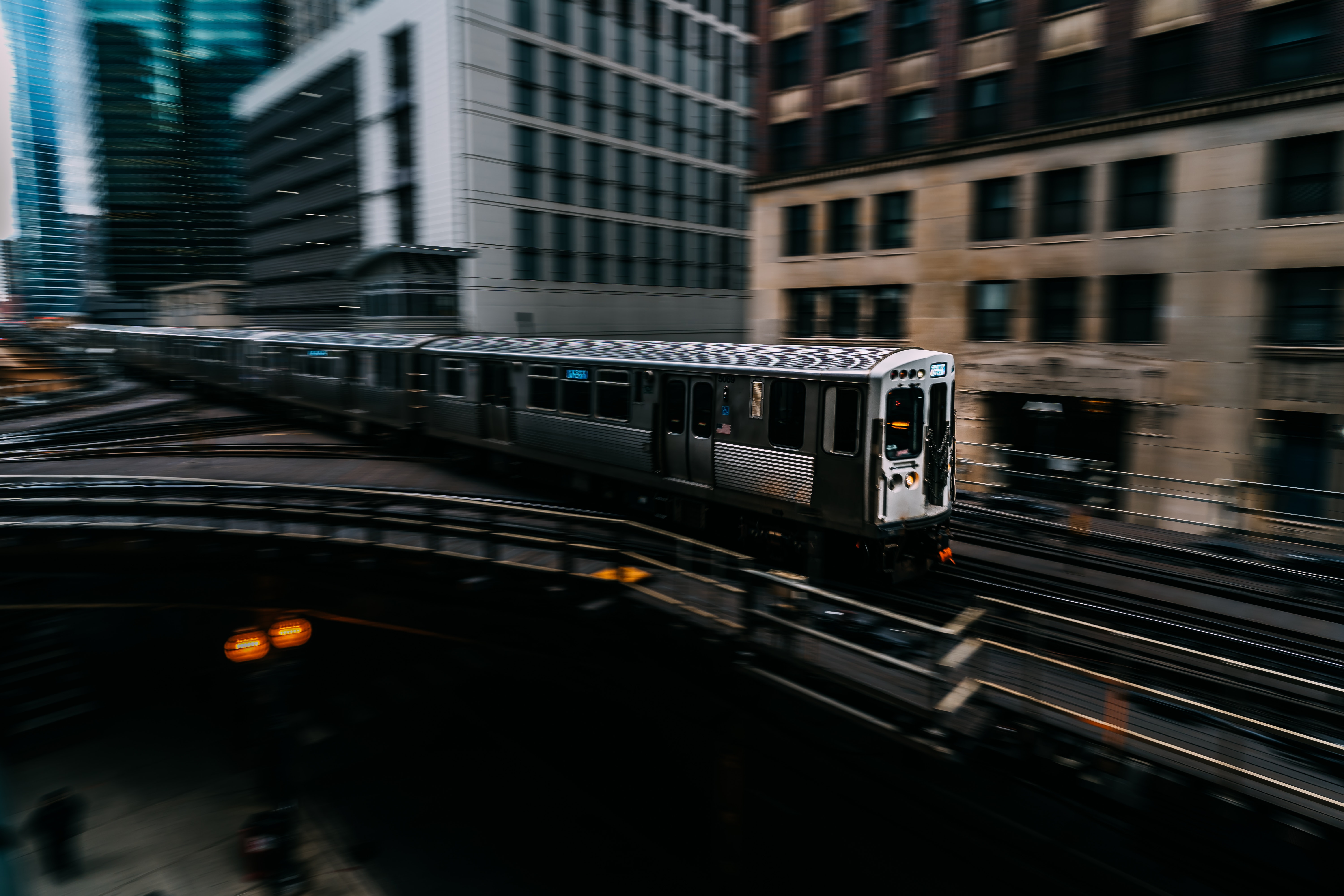 A speeding gray and black train