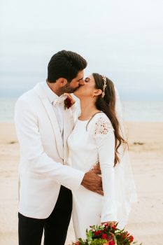 A bride and a groom kissing each other