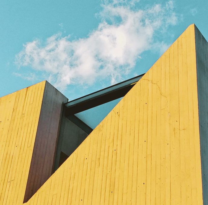 A yellow building on a background of blue sky
