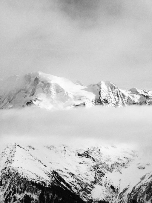 Black and white photo of a snow-covered rocky mountain