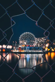 Illuminated silver dome behind a fence