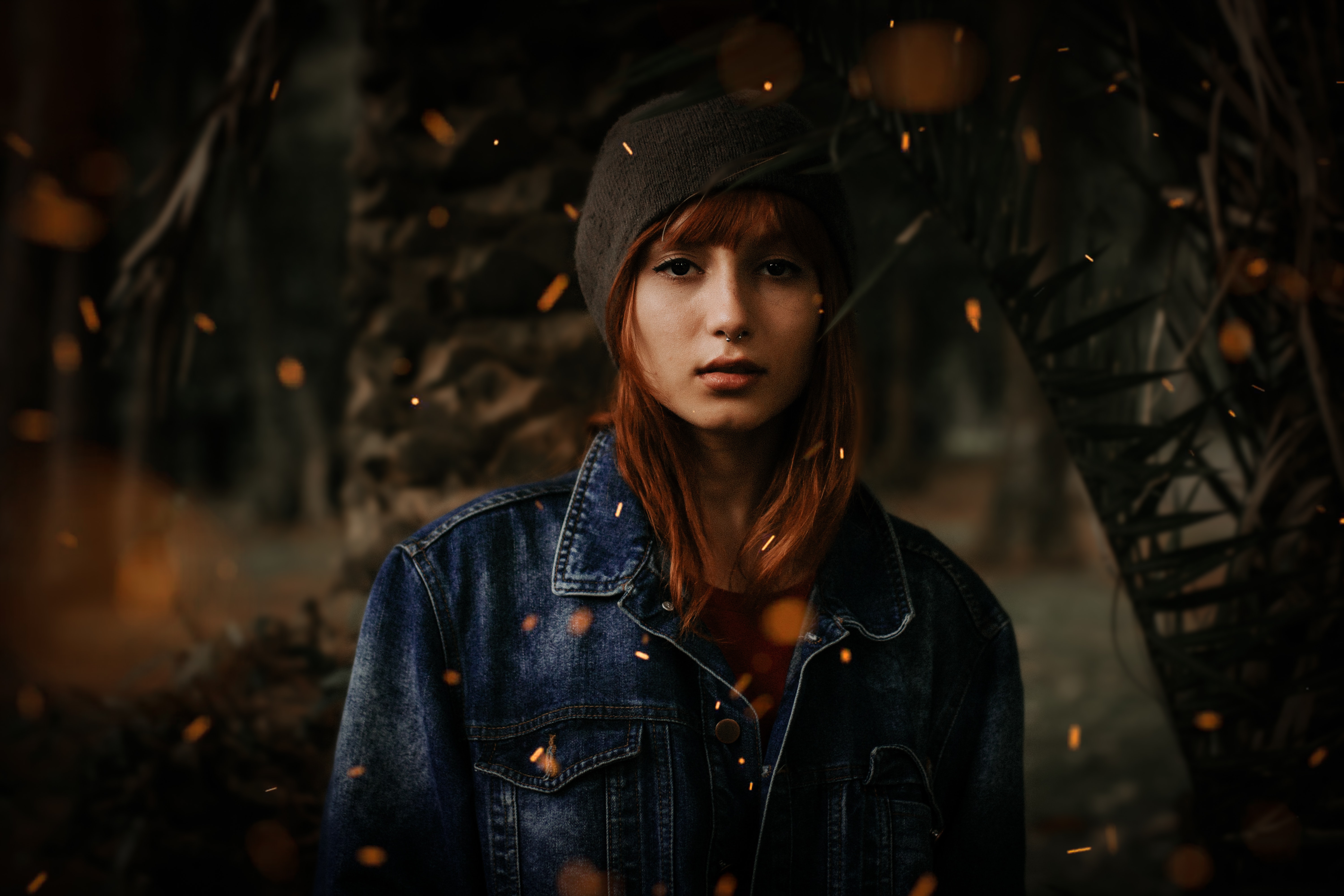 Photo of a young woman wearing a black hat and denim jacket