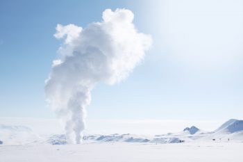 Smoke rising from a snow-covered field