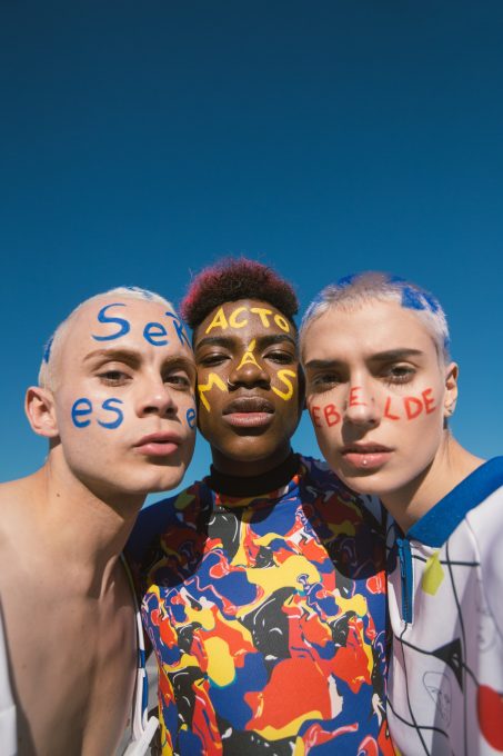 Three people with painted faces