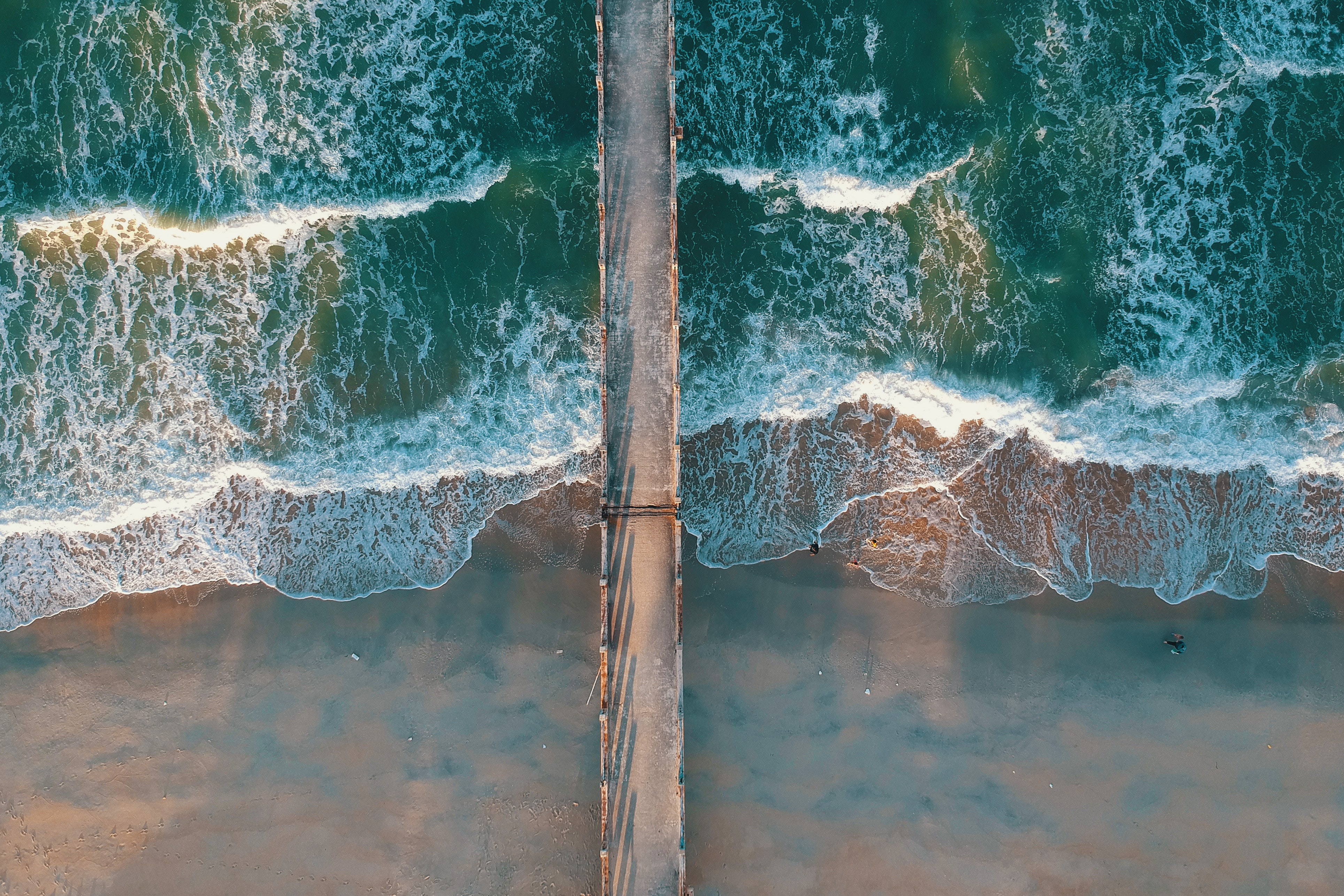 Top view photo of sea waves and a dock