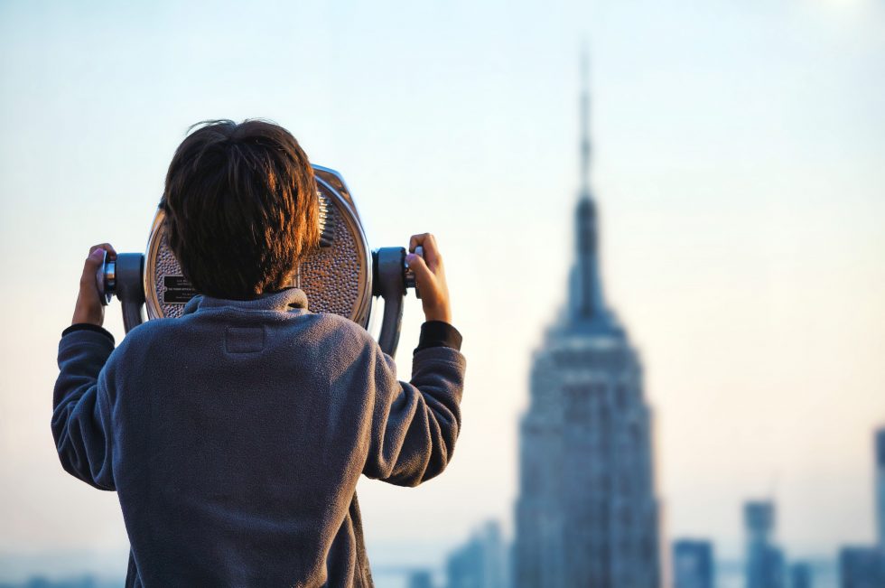 A boy looking at the Empire State Building