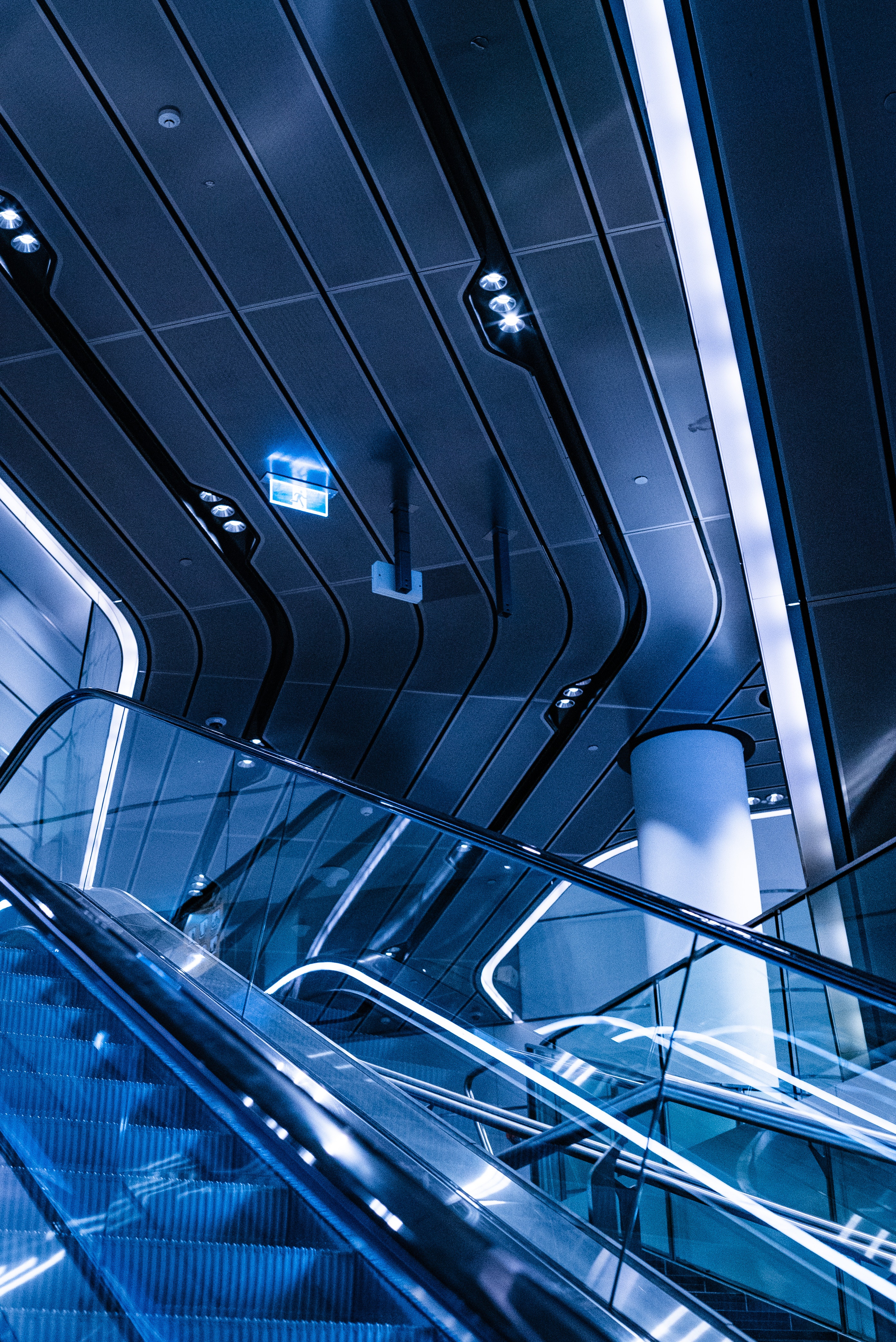 An escalator illuminated with blue light