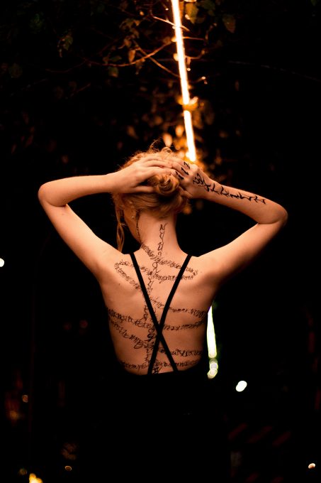 Back view of a woman with tattoos