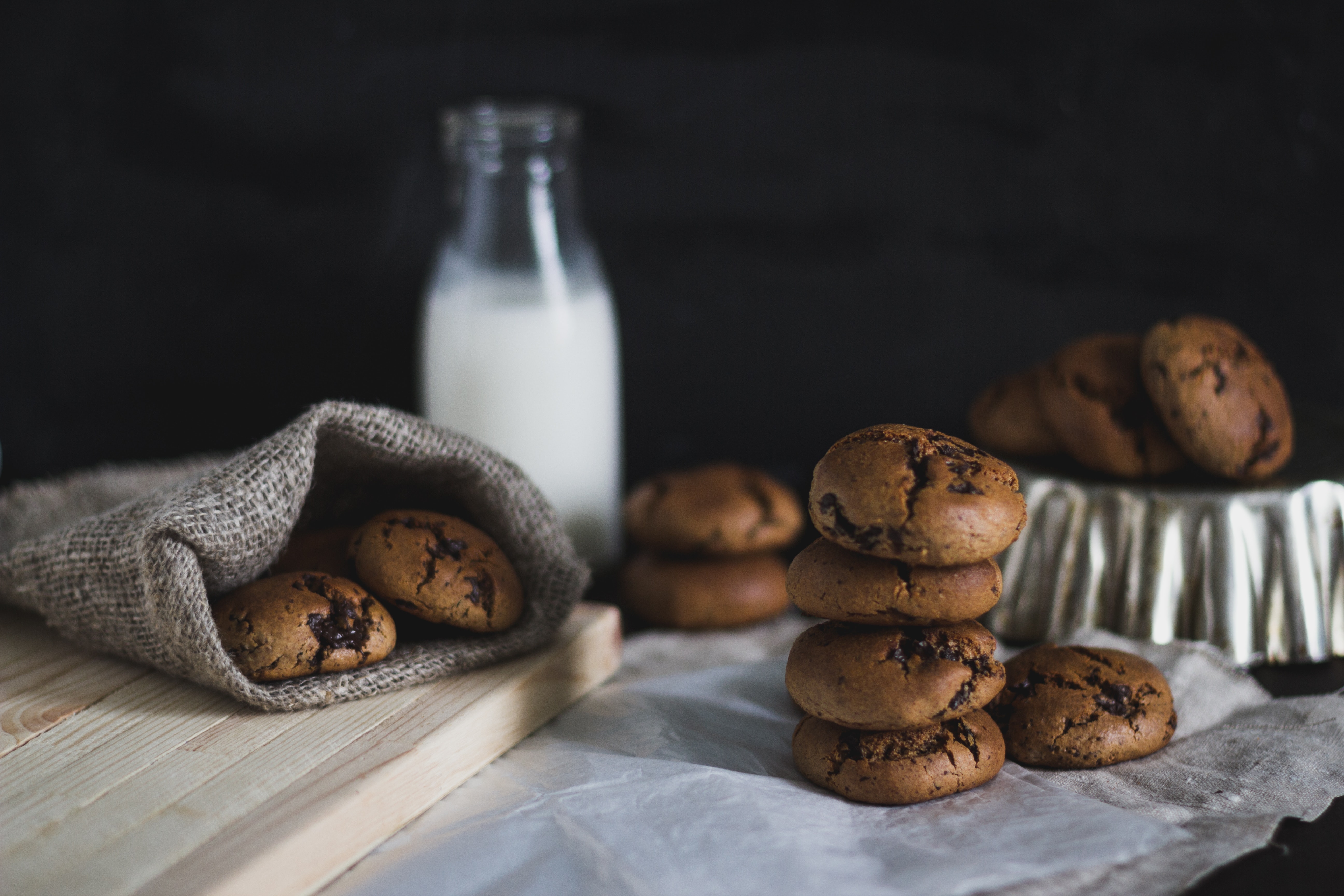 Baked cookies and a bottle of milk on a table