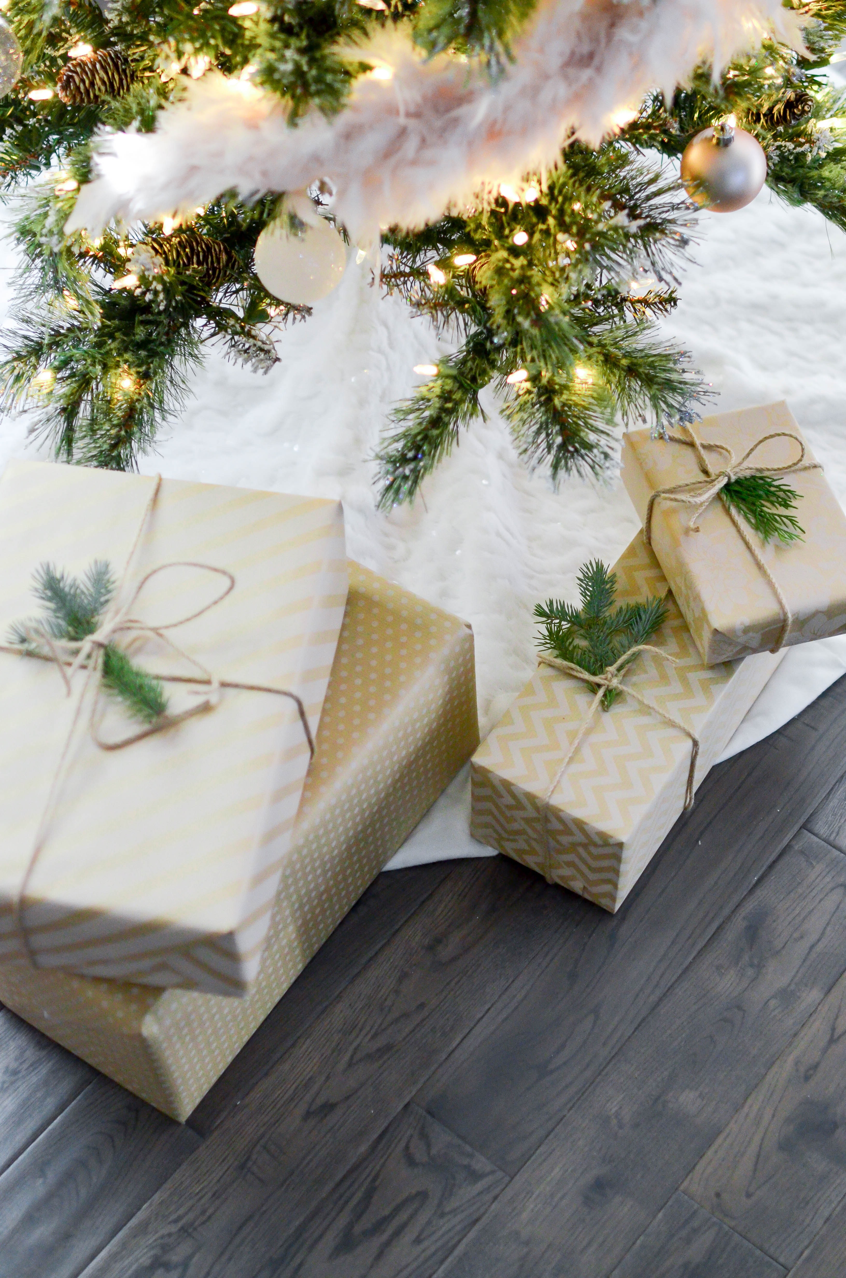 Four gift boxes near lighted string lights
