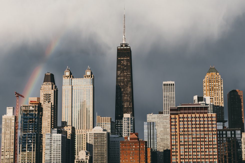 The rainbow stretching over high-rise buildings of a city
