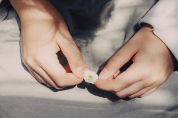 A person holding a flower