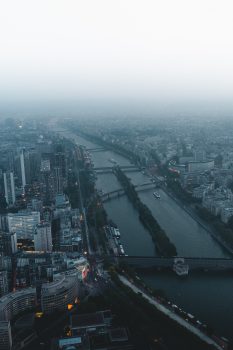 A river in the middle of a foggy city