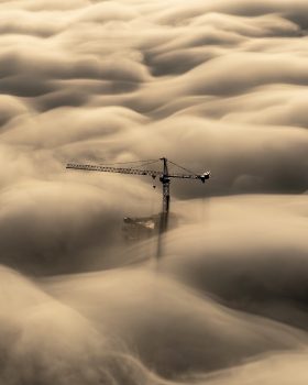 A tower crane above the clouds