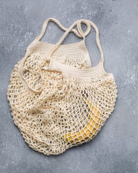 A white crocheted bag with a banana