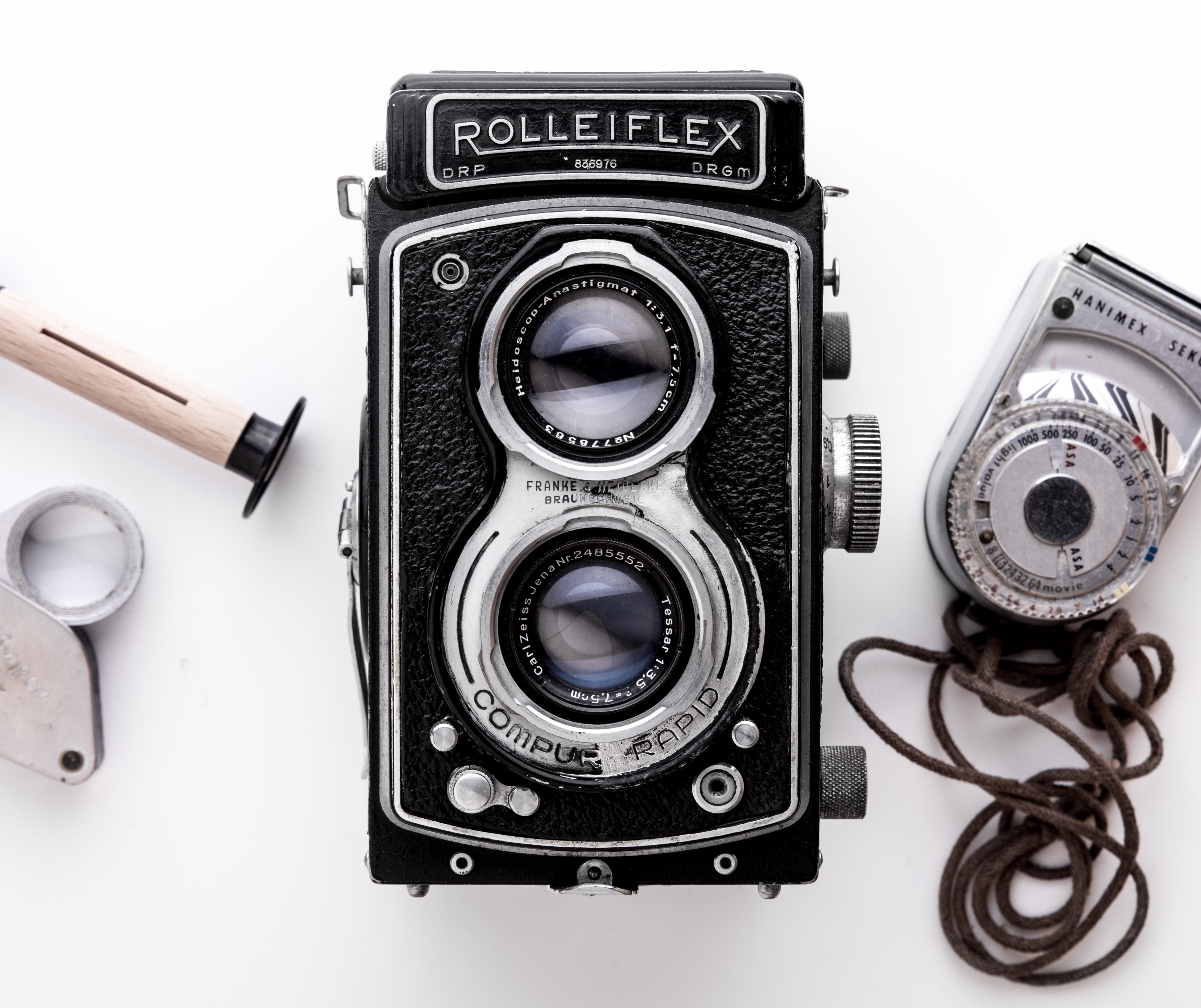 Black Rolleiflex camera on a white surface