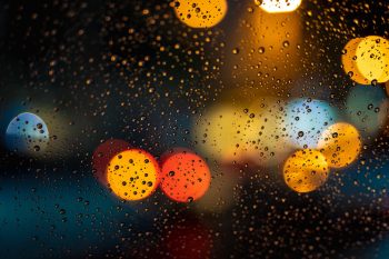 Bokeh photography of glass covered with drops
