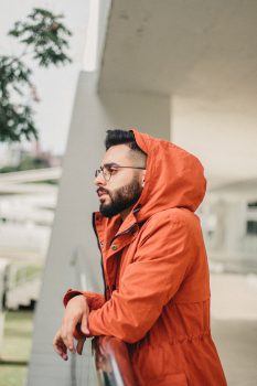 Photo of a man wearing an orange jacket