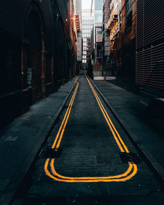 Photo of an empty alley in between buildings