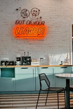 A coffee counter with a sign "out of your league" on the wall